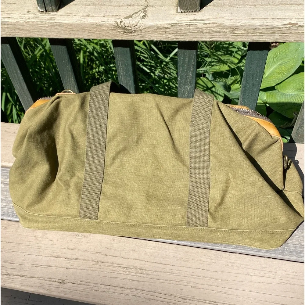 Vintage like new High Sierra leather and green canvas duffle bag.